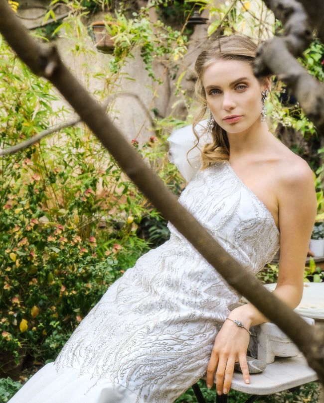 shine wedding dress woman leaning behind tree branch