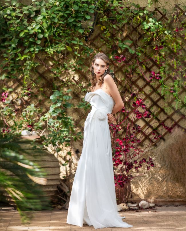 grace wedding dress in front of a bougainvillea